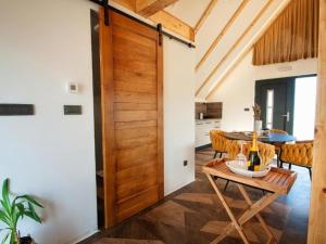 a wooden door in a dining room with a table at Family Resort Plitvice Lakes- Mountain view Tina in Rastovača