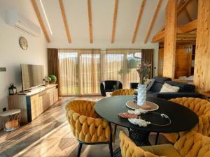 a living room with a table and chairs at Family Resort Plitvice Lakes- Mountain view Tina in Rastovača