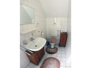 a bathroom with a sink and a toilet at Holiday home with 3 bedrooms in Papenburg-Obenede
