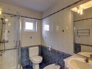 a bathroom with a toilet and a sink and a shower at Apartment in Hévíz with swimming pool in Hévíz +6 photos