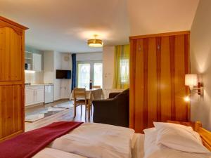 a hotel room with a bed and a kitchen at Apartment in Hévíz with swimming pool in Hévíz