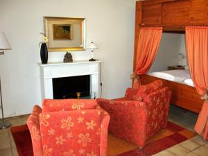 a living room with a couch and a chair and a bed at Holiday apartment 2 people in Borkum