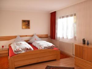 a bedroom with a bed with two pillows on it at Holiday home with 3 bedrooms in Frutenhof