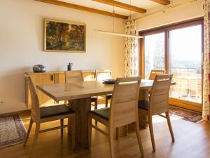 a dining room with a wooden table and chairs at Holiday home with 3 bedrooms in Frutenhof