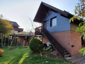 a house with a staircase in a yard at One-bedroom apartment in Harlingerode +14 photos