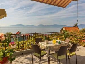 a table and chairs on a balcony overlooking the water at Two Bedroom Apartment With Terrace A4 in Brist