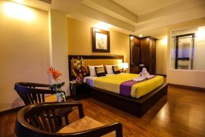 Postel nebo postele na pokoji v ubytování Madina Rayong Hotel