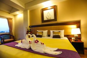 Postel nebo postele na pokoji v ubytování Madina Rayong Hotel