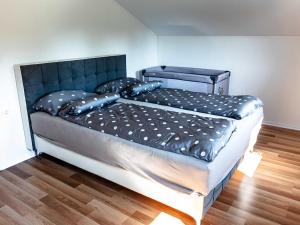 a large bed with a black headboard in a room at Tranquil Luxe Thermal Escape Mobile Home - Premium Mobile Home with Terrace in Mostec