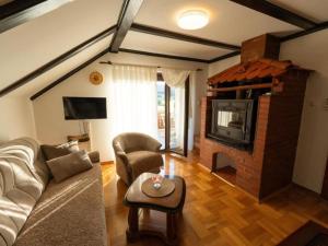un soggiorno con divano e camino di Villa Narnia - Three Bedroom Villa a Gornji Prozor