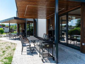 a group of tables and chairs on a patio at Tranquil Luxe Thermal Escape Mobile Home - Premium Mobile Home with Terrace in Mostec