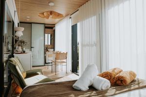 a bedroom with a bed with towels on it at The Bambino - By Casa Bicheno in Bicheno