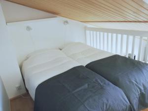a large bed in a room with a wooden ceiling at Levin KUURA in Kittilä