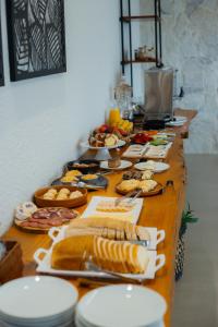 a long table filled with food on top at Casa Vêneto -Vale dos Vinhedos in Bento Gonçalves