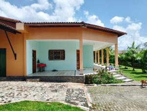 a white and orange house with a patio at COP30 house in Ananindeua