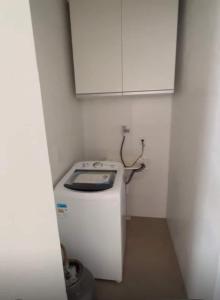 a small kitchen with a stove and a white cabinet at Apartamento Completo com 2 Camas in Euclides da Cunha