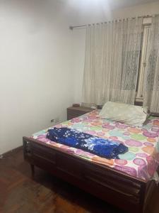 a bedroom with a bed with a colorful comforter at Business Home in Olivos