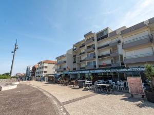 a building with tables and chairs in front of it at Biscarrosse Plage: T2 avec Terrasse, Parking, Face Océan - FR-1-319-200 in Biscarrosse-Plage +11 photos