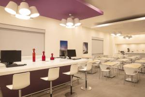 a large room with tables and chairs in a classroom at Fiesta Inn Express Monterrey Centro in Monterrey +29 photos