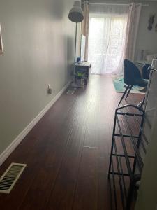 a living room with a wooden floor and a window at Peterborough Cosy Apartment in Peterborough +4 photos