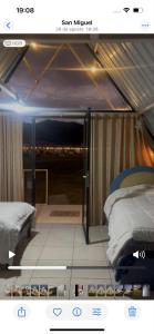 a view of a room with two beds in a tent at Cerro del Sol in San Miguel