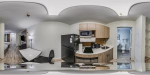 a rendering of a kitchen with a refrigerator at MainStay Suites Knoxville - Cedar Bluff in Knoxville