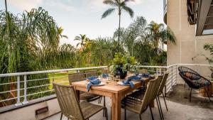 a wooden table with chairs on a balcony at Balboa Buyout by AvantStay - Condo w Views in DT San Diego in San Diego
