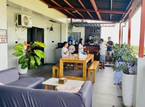 a group of people standing in a living room at Mamay's Homestay in Tagbilaran City