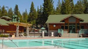 a large swimming pool in front of a building at Moosetrack by AvantStay Cozy Cabin In The Heart of Tahoe Donner in Truckee