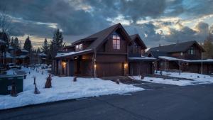 a house with snow on the ground in front at Maple by AvantStay Modern Mountain Home w Cozy Fire Pit 15 Mins frm Northstar in Ponderosa Fairway Estates