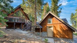 a home with a gambrel roof and a garage at Ember by AvantStay Majestic Entertainers Home w Pine Tree Views Close to Meeks Bay in Tahoma Meadows