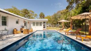 a swimming pool with a patio and a house at Sawyer by AvantStay Stunning Isle Of Palms Home w Pool in Isle of Palms
