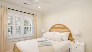 a white bedroom with a bed and a window at Sawyer by AvantStay Stunning Isle Of Palms Home w Pool in Isle of Palms +24 photos