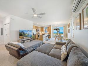 a living room with a couch and a table at Breath of Life by Kalo Homes in Makaha Valley +69 photos