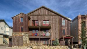 an old wooden house with a balcony at Ore Station 2 by AvantStay Modern Oasis in the Heart of Telluride w Hot Tub in Telluride