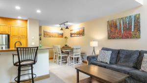a living room with a couch and a table at Cimarron Lodge 14 by AvantStay Ski-InSki-Out Property in Complex w Two Hot Tubs Permit3601 in Telluride