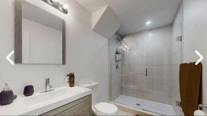 a bathroom with a shower and a toilet and a sink at Heaven on Earth in Ajax