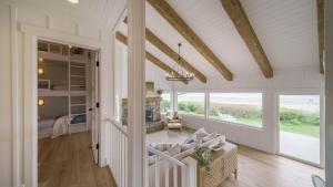 d'un salon avec des murs blancs et un plafond aux poutres apparentes. dans l'établissement Driftaway by AvantStay Direct Cannon Beach Access w Stunning Views, à Cannon Beach