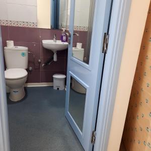 a bathroom with a toilet and a sink at Cosy Loft Temara Apartment in Temara