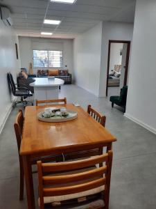 a dining room with a table and chairs in a room at Cosy Loft Temara Apartment in Temara