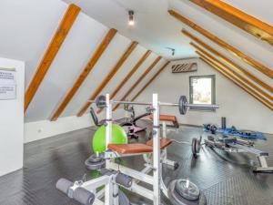 a gym with a treadmill and a exercise bike at Four Bedroom Holiday House Mali Raj with Pool in Oštarije