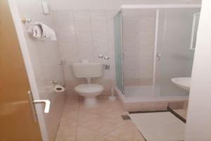 a bathroom with a toilet and a shower and a sink at Apartments Libertas - Studio with Balcony and Sea View - 3 in Rogoznica