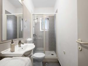 a bathroom with a sink and a toilet and a shower at One-Bedroom Apartment With Pool in Brodarica +18 photos
