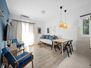 a living room with a couch and a table at One-Bedroom Apartment With Pool in Brodarica