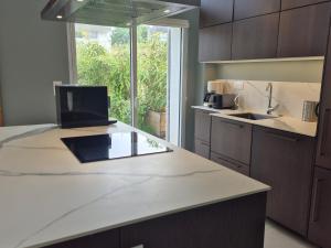 a kitchen with a white counter top and a sink at Superbe maison neuve à Groix, proche bourg - FR-1-813-2 in Groix +6 photos