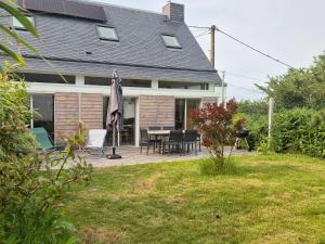 a house with a patio with a table and chairs at Superbe maison neuve à Groix, proche bourg - FR-1-813-2 in Groix