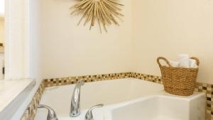 a white bath tub in a bathroom with a sink at Sunny by the Sound by AvantStay Coastal Escape in Coupeville +35 photos