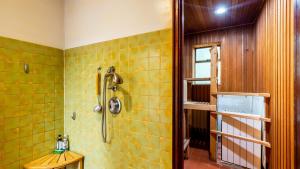 a bathroom with a shower with yellow tiles at Goss Lake Getaway by AvantStay Lakefront Escape in Langley +32 photos