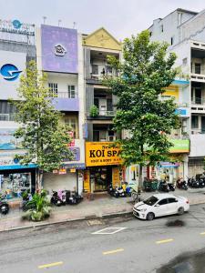 a white car parked on the side of a city street at TUNs House - Central 3BRs near Ben Thanh Market in Ho Chi Minh City