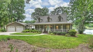 a house with a large yard with a driveway at A Frame of Mind by AvantStay Private Dock View in Lake Norman of Catawba